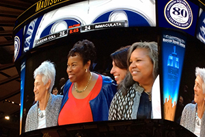 Beverly (far right) is captured on the Garden’s Jumbotron with (from left) her coach at Queens, Lucille Kyvallos, and fellow teammates Gail Marquis, a 1976 Olympic medalist, and Donna Orender, a former WNBA president.