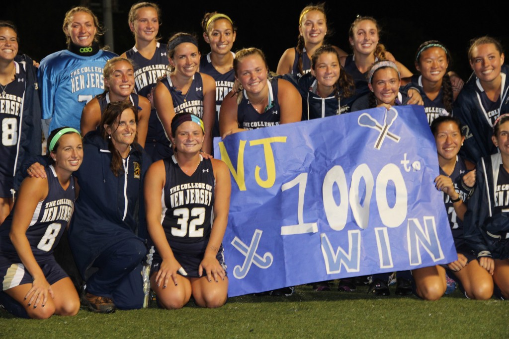 Players gather, post-game, to honor and celebrate Coach Pfluger’s milestone on October 1, 2015. Photo by Mark Gola