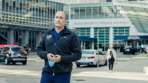 Dan Egan stands on a busy sidewalk in front of Massachusetts General Hospital. 