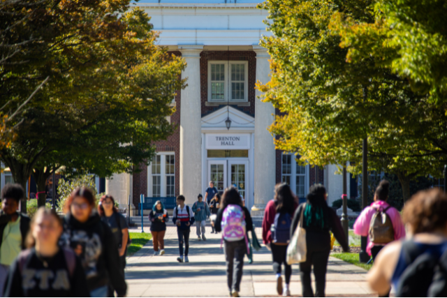 students walking on walkway in front of Trenton Hall