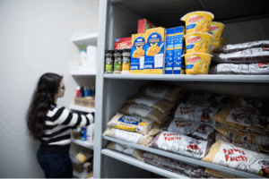 student works in campus food pantry